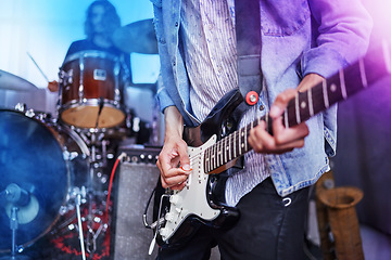 Image showing Guitar, band and man hands at music festival show playing rock with electric instrument with lights. Sound, musician and party with live talent and audio for punk event with people at a concert