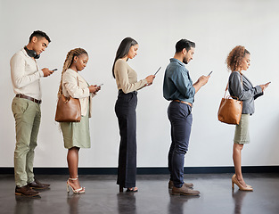 Image showing Group, professional and cellphone standing in a line at a job interview at an agency or workplace. Business, people and waiting with mobile for job interview at a company for recruitment or hr.