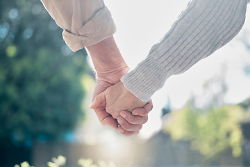 Image showing Senior couple, holding hands and love in support, care or relationship in nature garden or park outdoors. Hand of elderly man and woman touching in loving romance, trust or partnership together