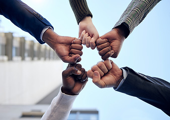 Image showing Group, hands and fist pump together for celebration, collaboration or people in business, company and teamwork. Businesspeople, below and celebrate success, deal or outdoor workplace team building