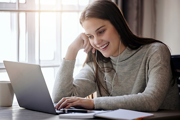 Image showing Happy woman with laptop, earphones and video call at table in living room, elearning or webinar study. Smile, computer and college online class, girl with headphones at home for university education.