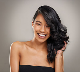 Image showing Haircare, beauty and portrait of happy woman in studio for cosmetics, treatment and shine on grey background. Hair, face and satisfied female model posing with volume, texture and keratin results