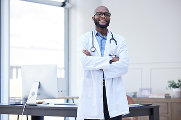 Image showing Doctor office, black man and portrait with arms crossed at a hospital with healthcare and wellness success. Face, happiness and medical employee with African male professional feeling proud from job