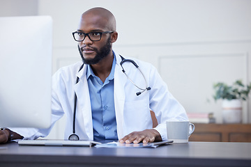 Image showing Black man, serious doctor and computer focus with medical and healthcare research in office. Wellness, hospital and clinic data reading of a African male professional working on tech for health