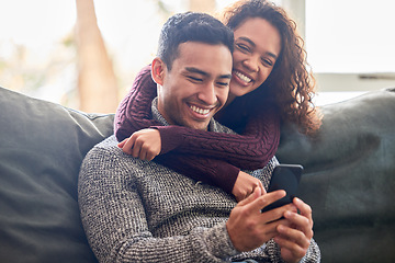 Image showing Happy couple, phone and sofa laughing for social media, internet meme or online streaming service at home. Young interracial woman and man or partner on website, connection and hug or love on couch