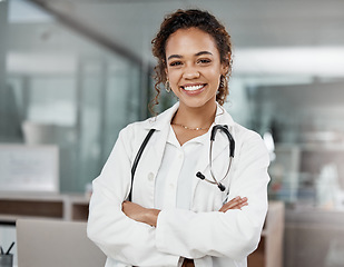 Image showing Healthcare, portrait of woman doctor with arms crossed and with stethoscope in a hospital building happy with a lens flare. Medical, wellness and female surgeon or nurse smile excited in a clinic