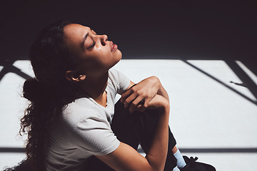 Image showing Mental health, sad woman sitting and isolated in room with tears on her face. Anxiety or depression, psychology or trauma patient and insomnia or depressed scared young female person sit alone