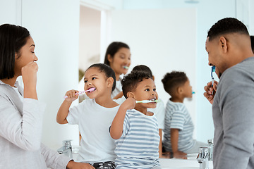 Image showing Dental, family brush their teeth and in bathroom of their home together in the morning. Care or love with hygiene, wellness and black people cleaning for healthcare with toothbrush at their house