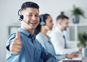 Image showing Man at callcenter, thumbs up in portrait and CRM, communication of support and agreement emoji. Contact us, customer service and tech, male agent with headset and smile, success and yes hand gesture