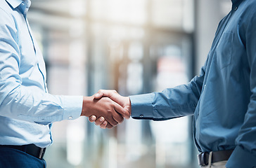 Image showing Thank you, businesspeople shaking hands and at office of their workplace together with a lens flare. Partnership or agreement, crm or greeting and colleagues with a handshake for interview at work