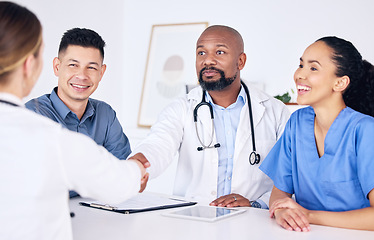 Image showing Handshake, teamwork or happy doctors in meeting for success, medical surgery contract or healthcare goals. Partnership, trusted black man or happy woman shaking hands with a nurse in hospital office