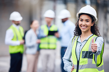 Image showing Thumbs up, woman architect and at a building site happy with her colleagues in the background. Thank you or agreement, engineer and cheerful or excited construction worker at industrial workplace