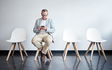 Image showing Phone, hiring and business man in waiting room for job interview, networking and recruitment. Mobile, internet and technology on chair with senior male employee for career, contact or hr consultation