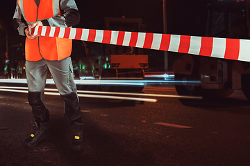 Image showing Worker blocks repair street.