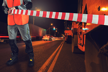 Image showing Worker blocks repair street.