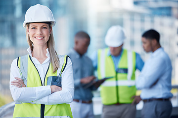 Image showing Portrait, arms crossed and a woman construction worker outdoor on a building site with her team in the background. Management, leadership and confidence with a female architect standing outside