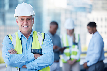 Image showing Portrait, arms crossed and a senior man construction worker outdoor on a building site with his team in the background. Management, leadership and confidence with a mature male architect outside