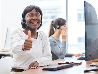 Image showing Thumbs up, woman with headset and on a computer desk in her office at work. Telemarketing or customer service, online communication or consultant and crm with African female person at workspace