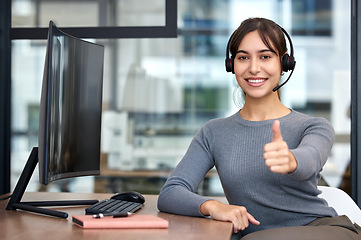 Image showing Thumbs, woman with headset and on a computer at her desk in a workplace office for success. Call center or customer service, crm and online communication with female person for support at her work