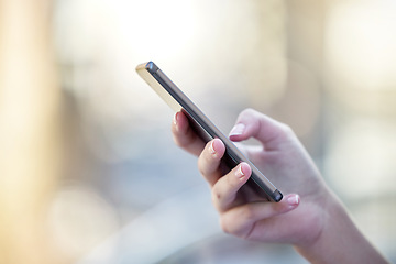 Image showing Hand, phone and communication with a woman typing a text message closeup on a blurred background. Mobile, contact and social media with a female person reading a text or networking alone outdoor