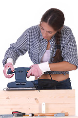 Image showing woman carpenter at work, sander