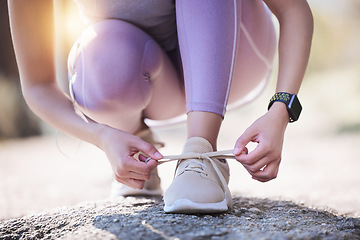 Image showing Woman, hands and tie shoes for running, exercise or workout on asphalt road or street outdoors. Hand of female person or runner tying shoe getting ready for walk, run or fitness exercising in nature