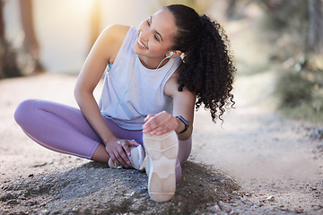 Image showing Happy woman, fitness and stretching body in nature for running, exercise or workout outdoors. Fit, active or sporty female person in warm up leg or foot stretch for exercising or training in forest