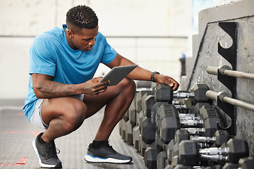 Image showing Check list, man with a tablet and at the gym checking weights equipment. Fitness or workout, exercise or health wellness and African male worker with smartphone working for inventory training