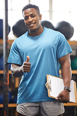 Image showing Thumbs up, portrait and fitness man in gym, clipboard and checklist for workout results, progress and like, yes or okay hand. African person, athlete or bodybuilder paperwork and thank you sign