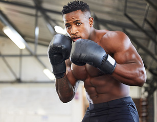 Image showing African man, boxing and punch in gym for fitness, focus or training for growth, goal and wellness for competition. African guy, boxer and gloves for exercise, wellness or martial arts club for sports