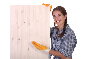 Image showing woman carpenter holding wooden plank