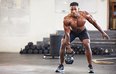 Image showing Black man, fitness and weightlifting with kettlebell for workout, exercise or training at the gym. African male person or muscular bodybuilder lifting weight for strength sports or intense exercising