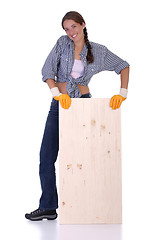 Image showing woman carpenter holding wooden plank