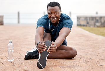 Image showing Stretching legs, fitness and portrait of black man in park for exercise, marathon training and running. Sports, music and male person stretch for warm up, workout and listen to audio for wellness