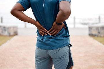 Image showing Man, fitness and back pain after workout, cardio exercise or running and training outdoors. Rear view of male person, athlete or runner with sore spine, injury or ache and bone inflammation in nature