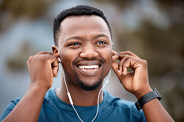 Image showing Black man, earphones and listening to music with smile in workout, exercise or cardio training in nature. Happy African male person, athlete or runner smiling for audio sound track or outdoor fitness