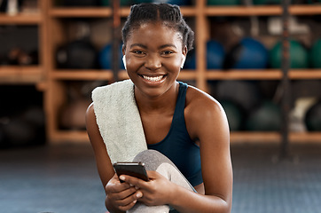 Image showing Happy black woman, fitness and portrait with phone for social media, communication or networking at gym. Face of African female person typing, texting or chatting on smartphone after workout exercise