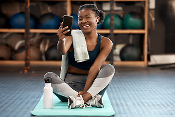 Image showing Phone, selfie and black woman fitness influencer on social media on a cellphone during workout or exercise in a gym. Health, wellness and young person or athlete happy online, internet or web