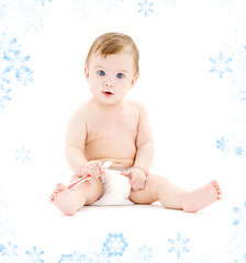 Image showing baby boy in diaper with toothbrush