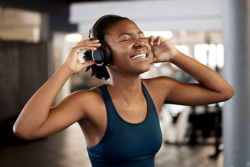 Image showing Black woman, fitness and listening to music on headphones in workout, exercise or training at gym. Happy African female person or athlete enjoying audio sound track on headset for exercising indoors