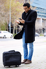 Image showing Frustrated businessman, phone and lost in the city with luggage for travel, commute or immigration. Upset or confused man annoyed on mobile smartphone for loss, issue or problems outside a urban town