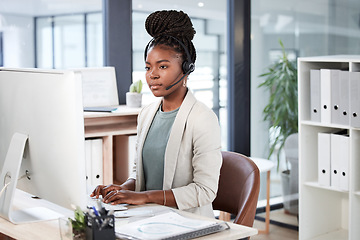 Image showing Call center, computer and black woman typing for telemarketing, customer service or support. Contact us, crm or African female sales agent, consultant or person focus on business in help desk office.