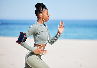 Image showing Fitness, beach and woman running, listening to music, exercise podcast or training, cardio and health technology. Ocean, focus and african person, runner or athlete workout, training and phone audio