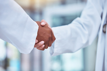 Image showing Closeup, doctors and handshake in hospital for partnership, deal and collaboration for wellness, healthcare and respect. Medic team, shaking hands and welcome for interview, hiring and recruitment