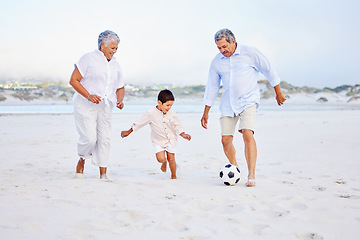 Image showing Beach, football and grandparents playing with kid on vacation or holiday happy for sand soccer or sports. Travel, summer and elderly man and woman kicking a ball with child at the ocean together