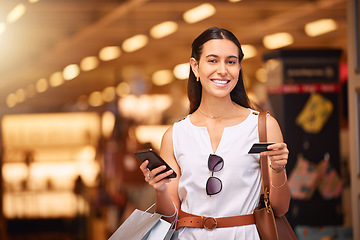 Image showing Phone, credit card and a woman with a shopping bag in mall for fashion, sale or discount deal. Portrait of happy customer person with smartphone for retail promotion offer and online banking app