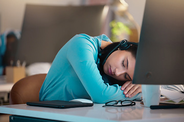 Image showing Call center, customer service and a woman consultant sleeping at her desk in the office late at night. Exhausted, overworked and a tired female employee asleep while consulting for crm or sales