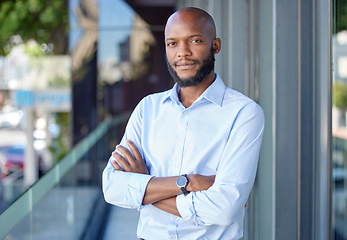 Image showing Serious, crossed arms and portrait of a businessman with confidence in city by office building. Success, happy and professional African male financial analyst standing outside workplace in urban town