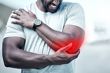 Image showing Fitness, elbow and injury with a sports man holding his joint in pain while outdoor for a workout. Exercise, anatomy and accident with a male athlete feeling tender while training for recreation