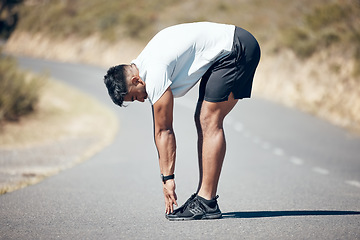 Image showing Stretching, running and fitness with man in road for training, workout and exercise. Muscle, energy and cardio performance with male runner and warm up in nature for marathon, start and health